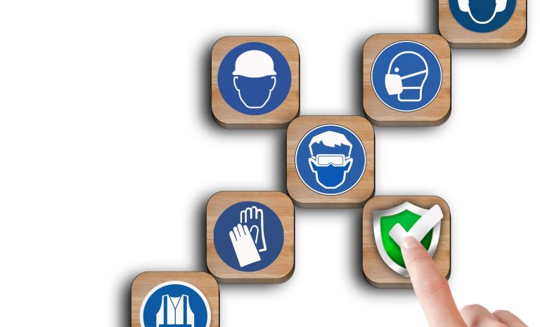 The,Hand,Touch,At,Wooden,Block,With,The,Safety,Icon