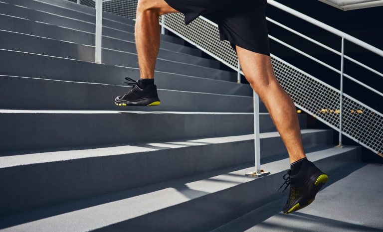 Athletic man running on stairs during interval training