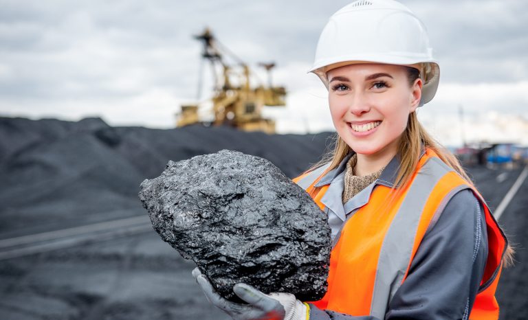 Worker,With,Piece,Of,Coal,In,Her,Hand,At,An